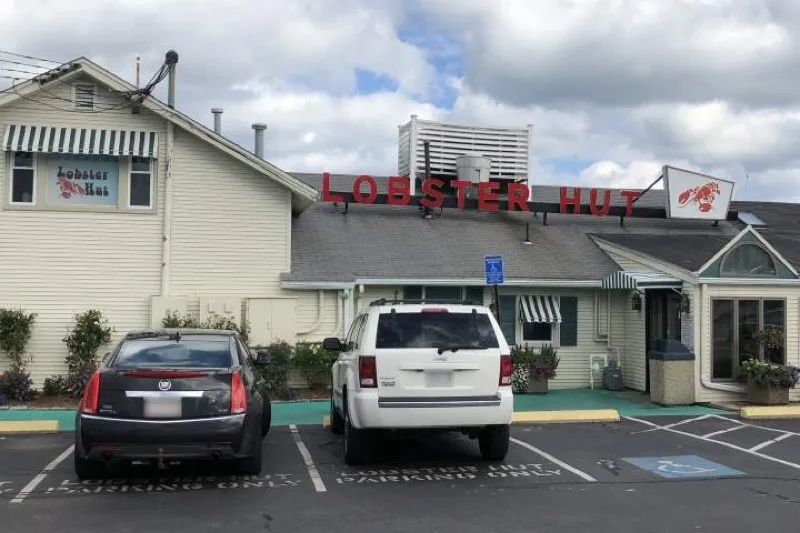 Lobster Hut exterior with iconic red sign at 25 Town Wharf Plymouth MA